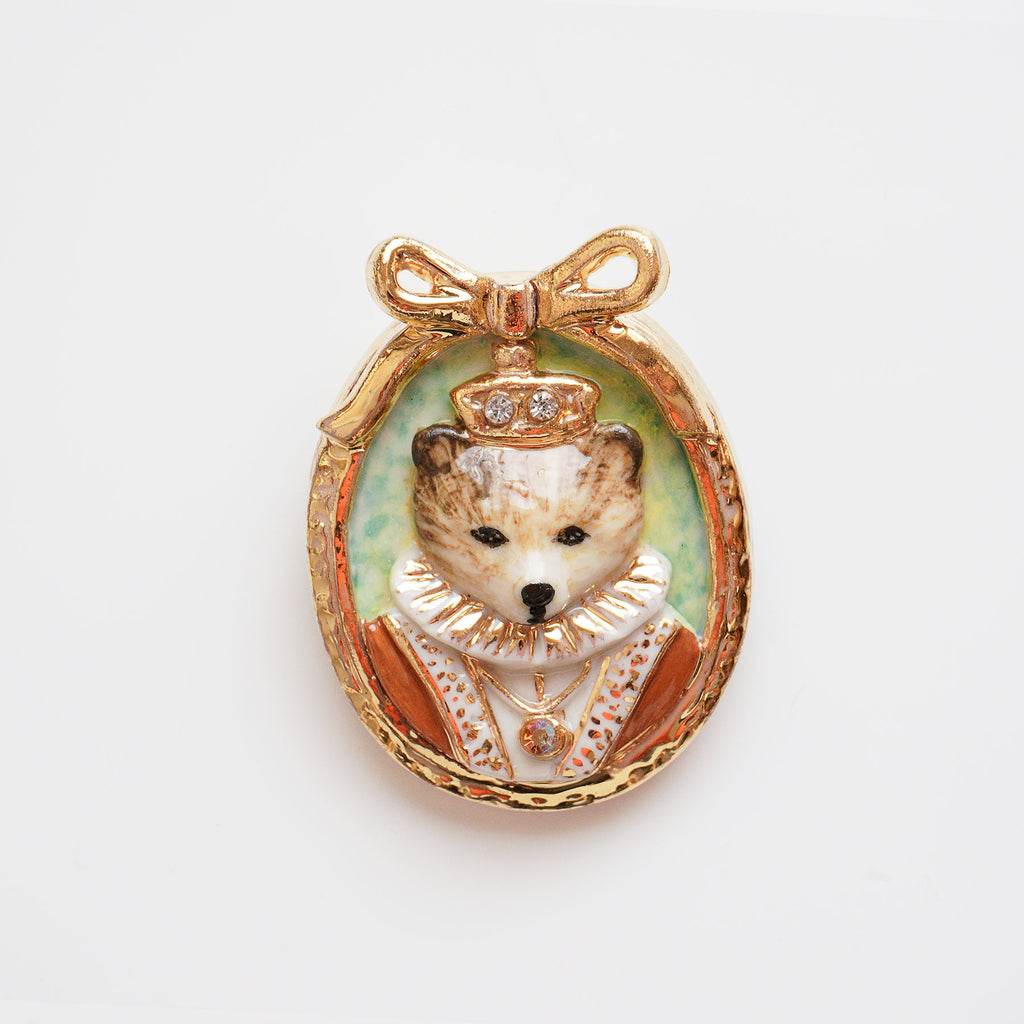 Once it comes to Hop Skip & Flutter, you can ensure the design will be not just elegantly beautiful but also smart and playful. Bear Cameo portrait brooch looks stunning in her elegant queen costume. Designed and handmade from porcelain in portrait design.